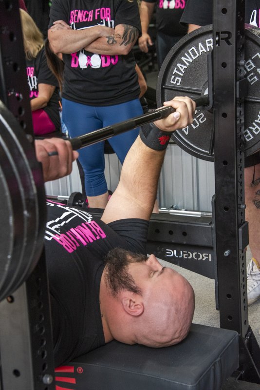 Overall winner Nick Curl racks his weights with no problem.